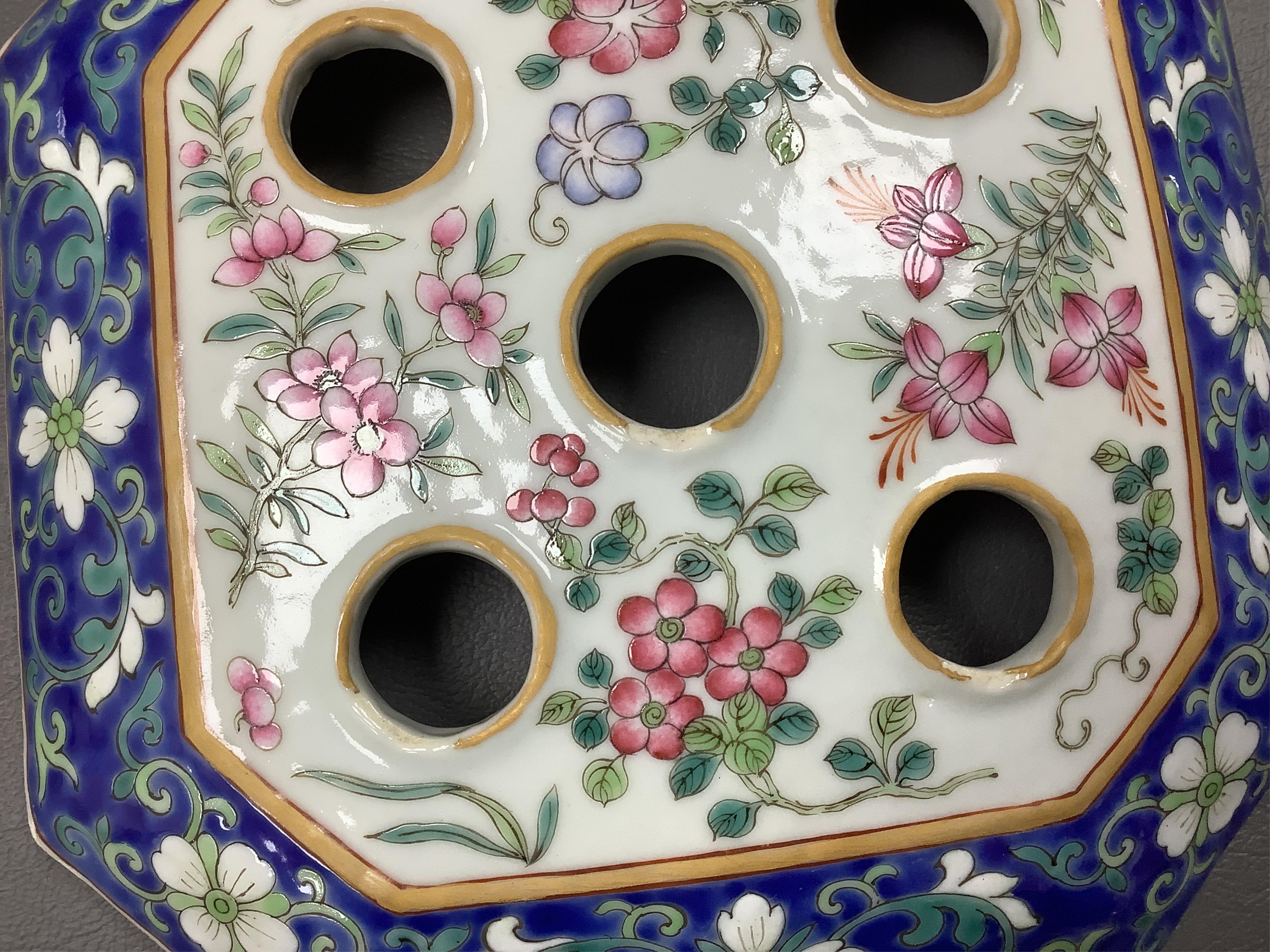 A pair of Chinese famille rose bough pots, painted with figures and calligraphy, 24cm high. Condition - one cover damaged